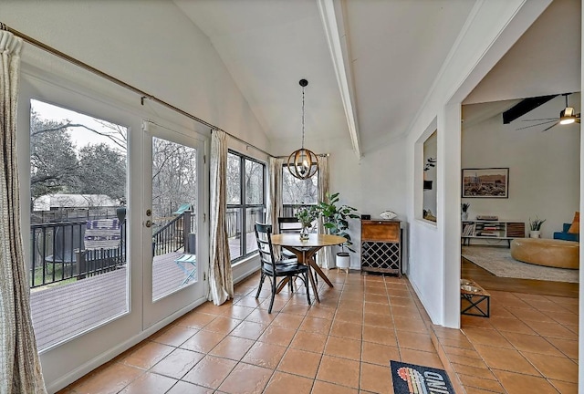 sunroom / solarium featuring lofted ceiling with beams and ceiling fan with notable chandelier