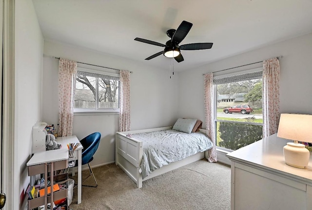 bedroom with ceiling fan, baseboards, and carpet flooring