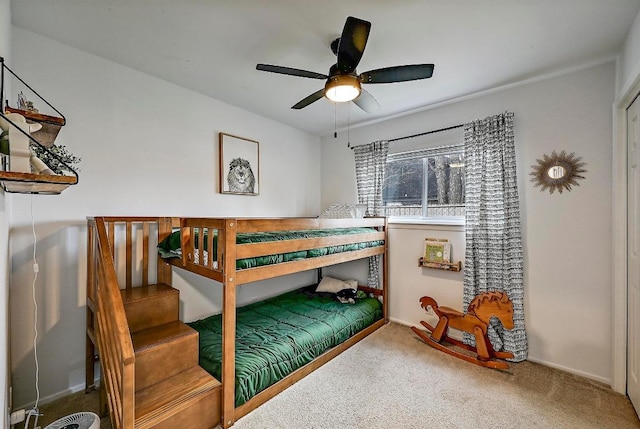 carpeted bedroom featuring a ceiling fan and baseboards