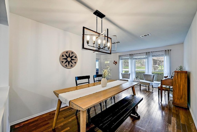 dining space with dark wood-style floors, visible vents, a notable chandelier, and baseboards