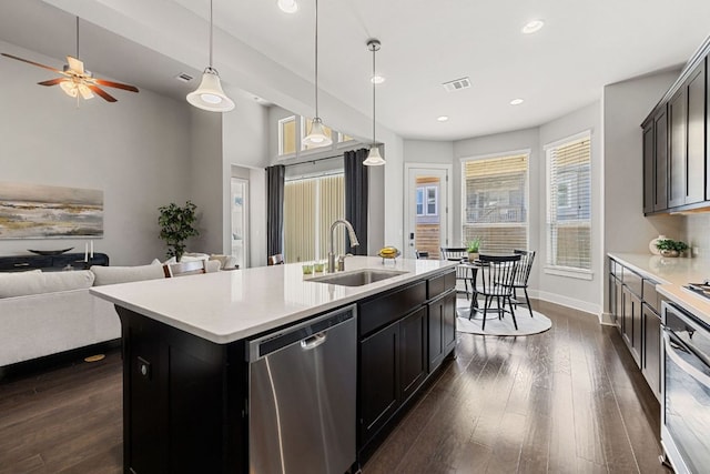 kitchen with visible vents, dark wood finished floors, appliances with stainless steel finishes, open floor plan, and a sink