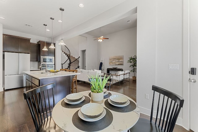 dining room featuring visible vents, dark wood finished floors, ceiling fan, stairs, and recessed lighting