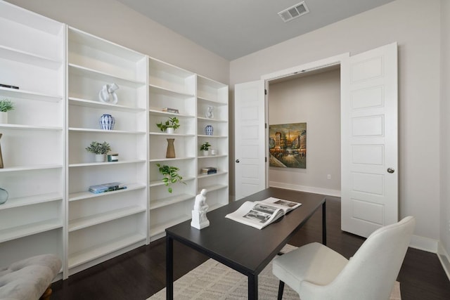 office featuring baseboards, visible vents, and dark wood finished floors