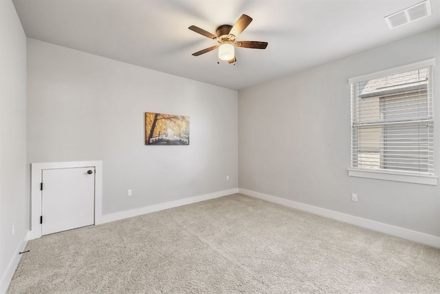 spare room with baseboards, ceiling fan, visible vents, and carpet flooring