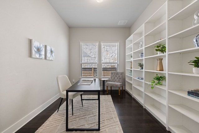 office with dark wood-style floors, visible vents, and baseboards