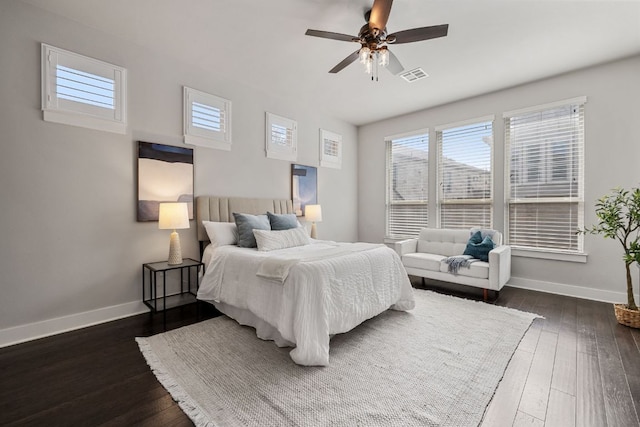 bedroom featuring dark wood-style flooring, visible vents, ceiling fan, and baseboards