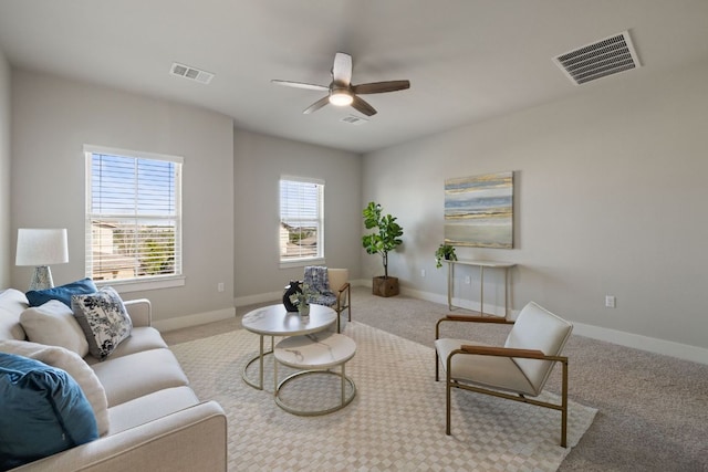 living area featuring carpet, visible vents, and baseboards