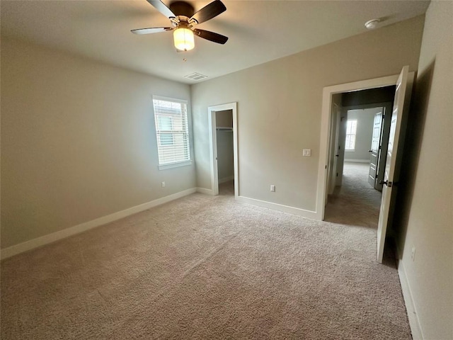 unfurnished bedroom featuring visible vents, light carpet, and baseboards