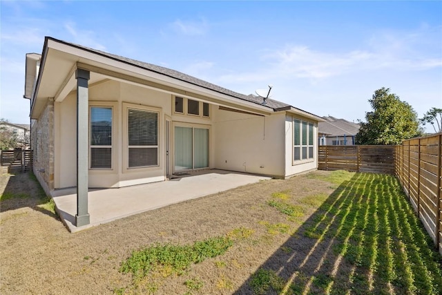 rear view of property with a patio area, a fenced backyard, and stucco siding