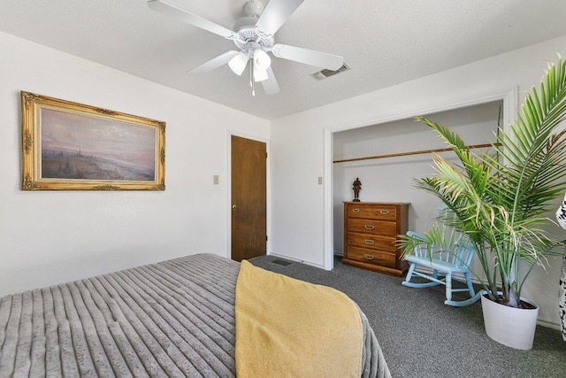 carpeted bedroom featuring ceiling fan, a textured ceiling, and visible vents