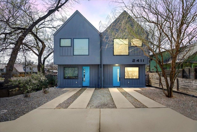 view of front of property featuring board and batten siding and fence