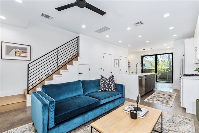 living area featuring concrete flooring, visible vents, and recessed lighting