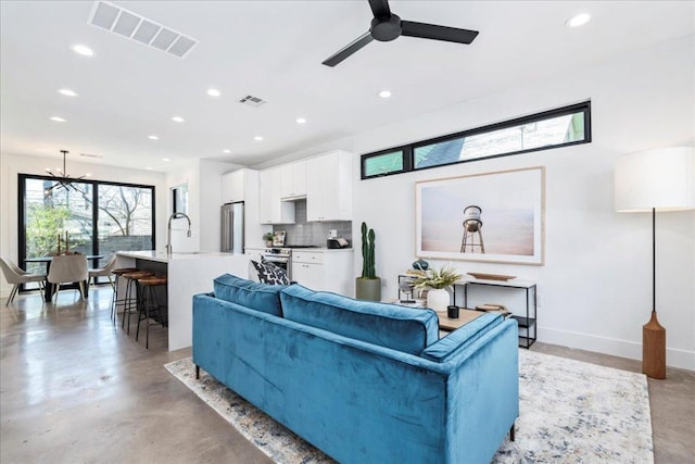 living area featuring recessed lighting, visible vents, concrete floors, and baseboards