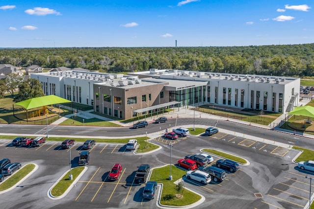 drone / aerial view featuring a forest view