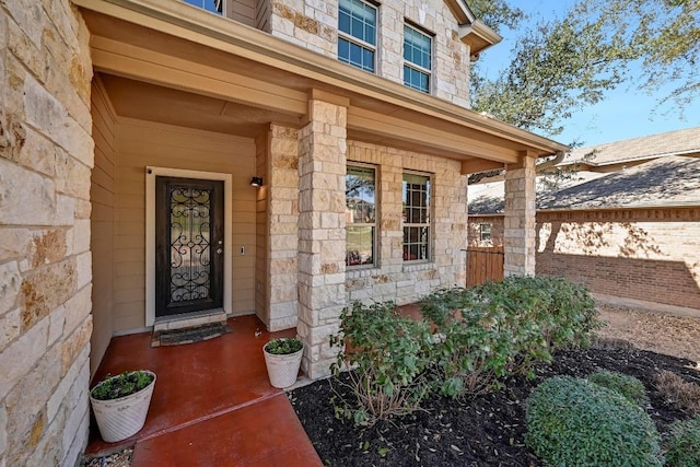 property entrance with stone siding