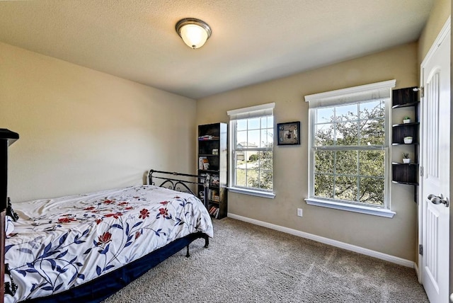 bedroom featuring carpet and baseboards