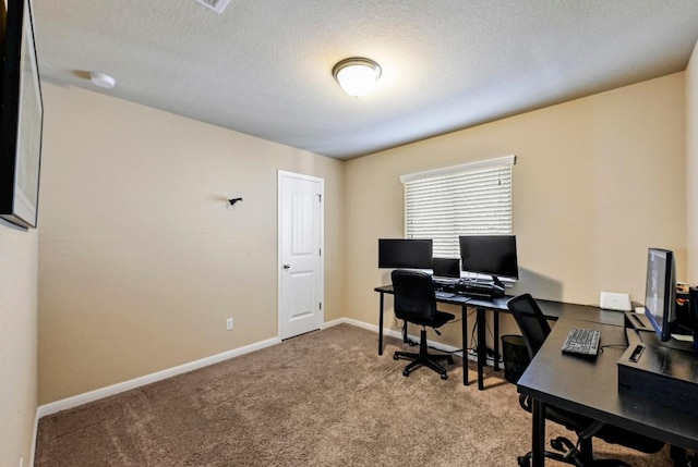 home office featuring a textured ceiling, carpet, and baseboards