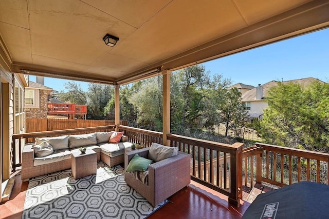 wooden deck with fence and an outdoor hangout area