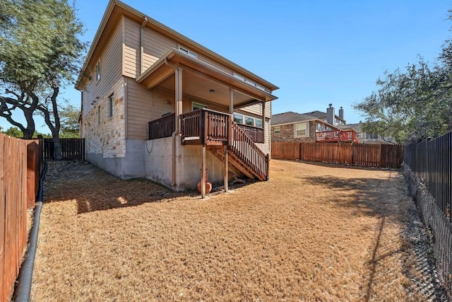 exterior space featuring a fenced backyard and stairs