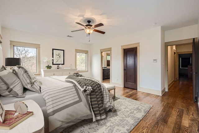 bedroom with baseboards, visible vents, a ceiling fan, connected bathroom, and wood finished floors