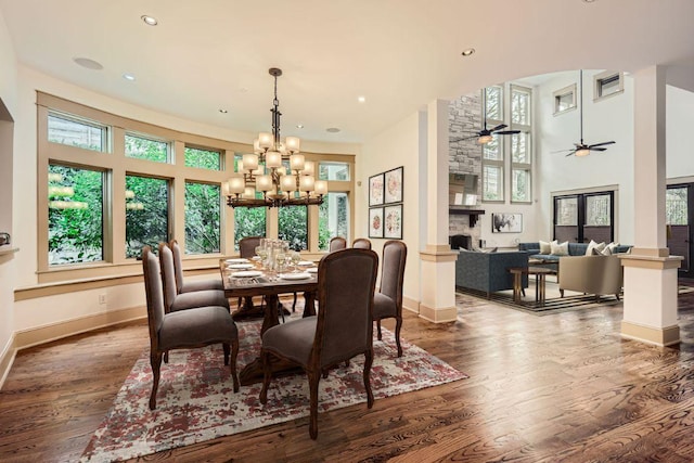 dining space featuring ceiling fan with notable chandelier, plenty of natural light, and wood finished floors