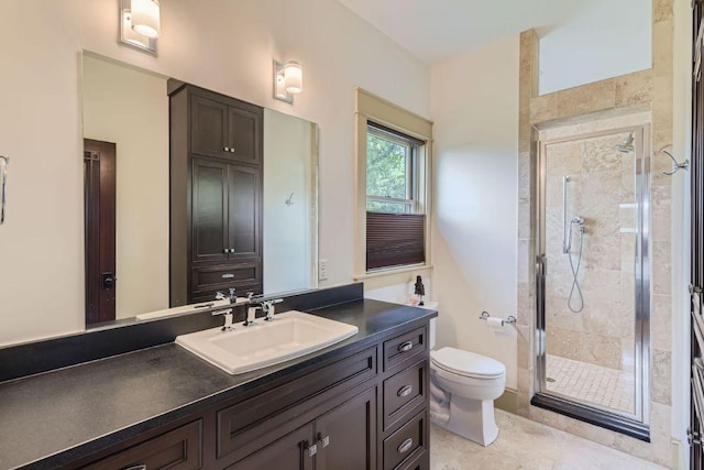 bathroom featuring toilet, a stall shower, and vanity