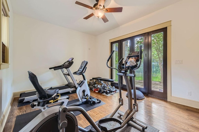 workout area with ceiling fan, baseboards, wood finished floors, and french doors