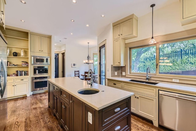 kitchen featuring dark brown cabinetry, dark wood-type flooring, stainless steel appliances, light countertops, and a sink