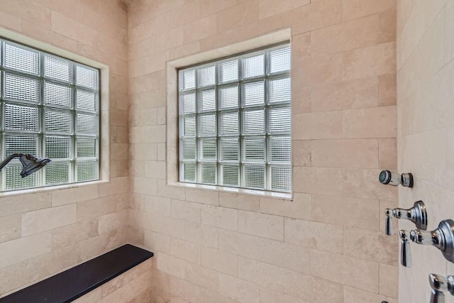 bathroom featuring a healthy amount of sunlight and tiled shower