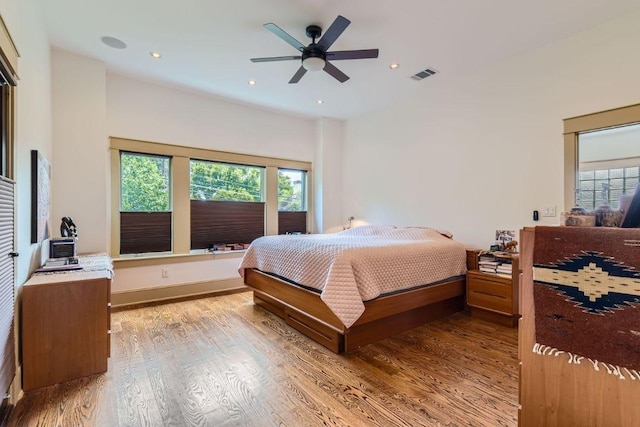 bedroom featuring multiple windows, visible vents, wood finished floors, and recessed lighting