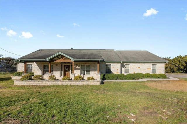 view of front facade with stone siding, a porch, and a front lawn