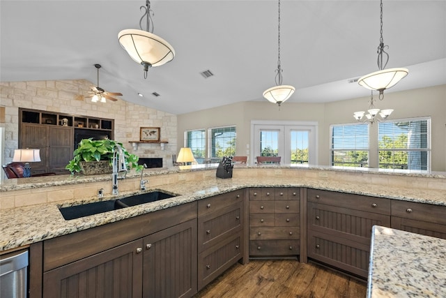 kitchen featuring lofted ceiling, a wealth of natural light, a sink, and visible vents