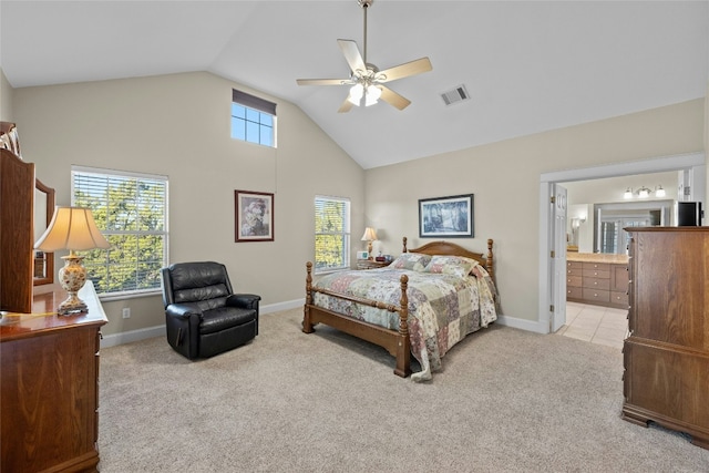 carpeted bedroom with baseboards, visible vents, connected bathroom, a ceiling fan, and high vaulted ceiling