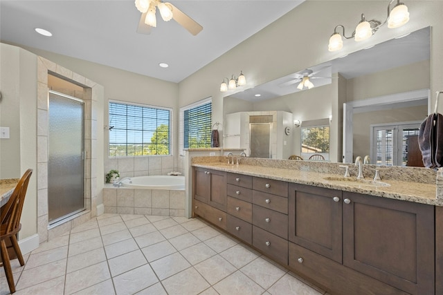 bathroom featuring a bath, a stall shower, tile patterned flooring, and a sink