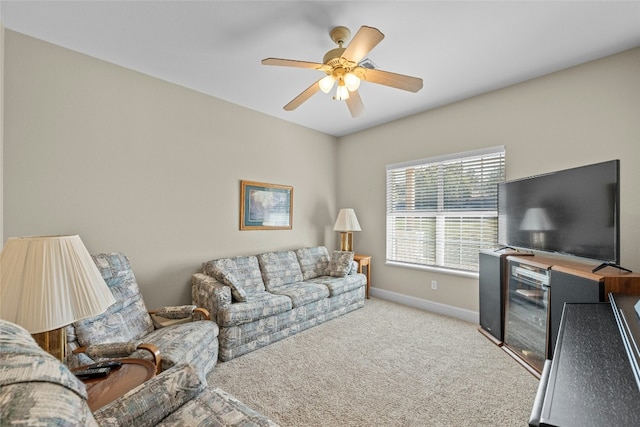 living room featuring carpet flooring, a ceiling fan, and baseboards