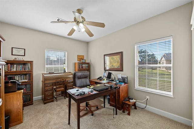 office space with light carpet, ceiling fan, and baseboards