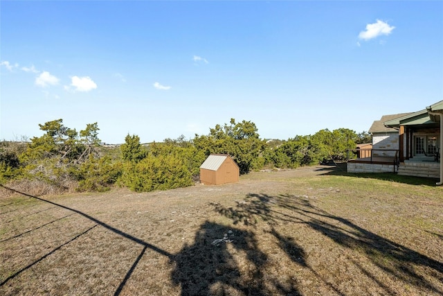 view of yard featuring an outbuilding and a storage shed