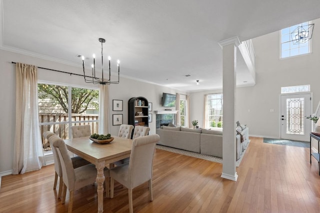 6202 Sotol Cv, Austin, TX 78759 - dining space with a chandelier, light wood-style flooring, healthy amount of natural light, and ornamental molding