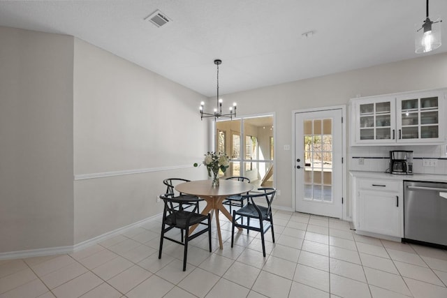 dining room with light tile patterned floors, visible vents, baseboards, and an inviting chandelier