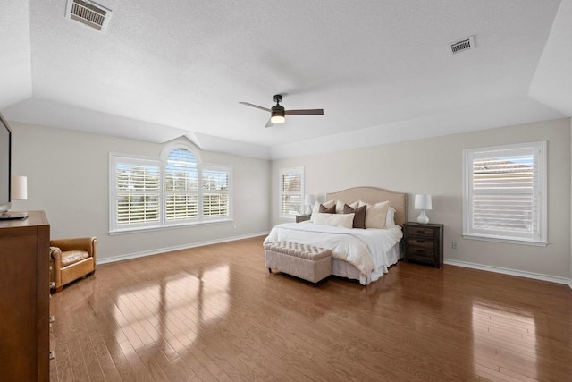 6202 Sotol Cv, Austin, TX 78759 - bedroom with wood finished floors, baseboards, a textured ceiling, and ceiling fan