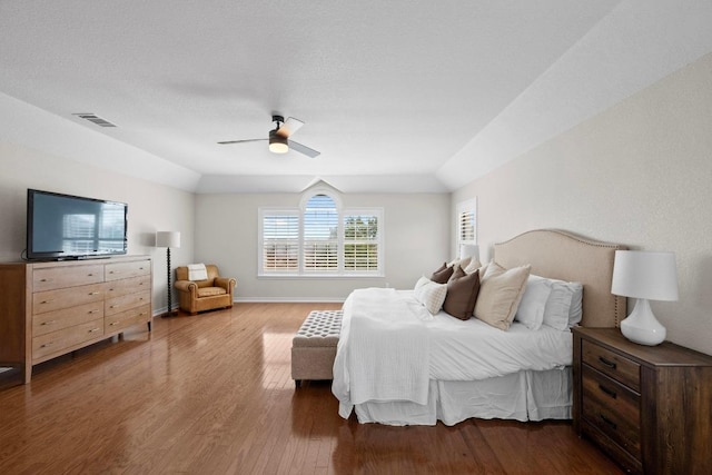 6202 Sotol Cv, Austin, TX 78759 - bedroom with wood finished floors, a ceiling fan, vaulted ceiling, and baseboards