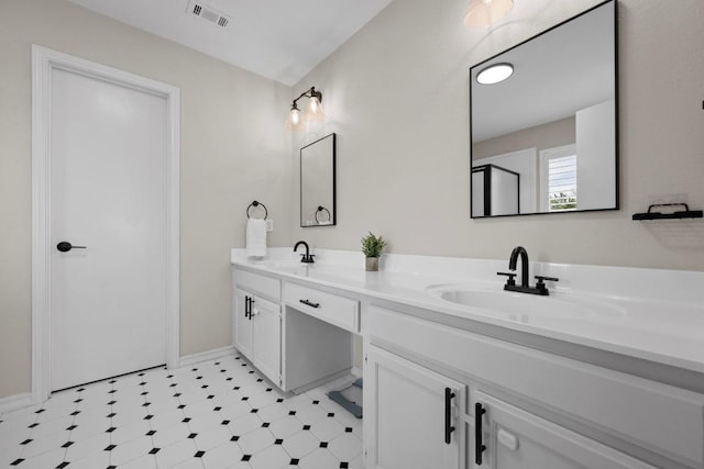 bathroom featuring double vanity, visible vents, tile patterned floors, and a sink