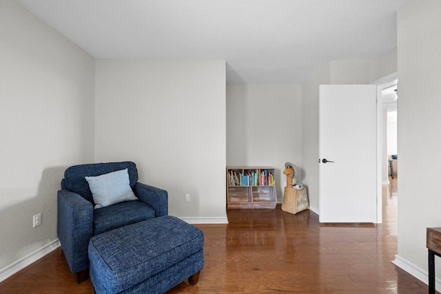 sitting room featuring baseboards and wood finished floors