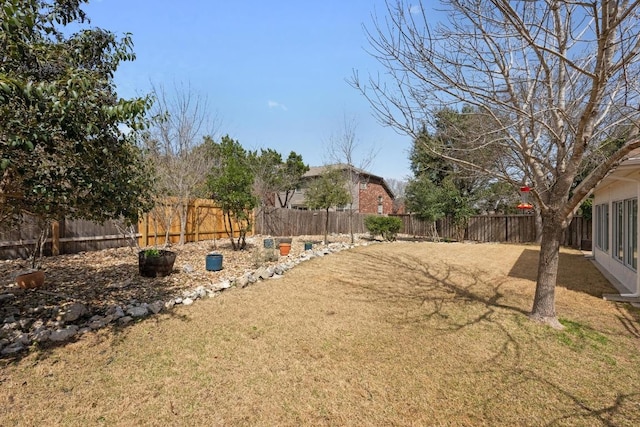 view of yard with a fenced backyard