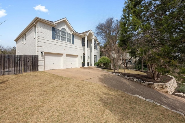 view of front of property featuring fence, concrete driveway, an attached garage, a front yard, and brick siding