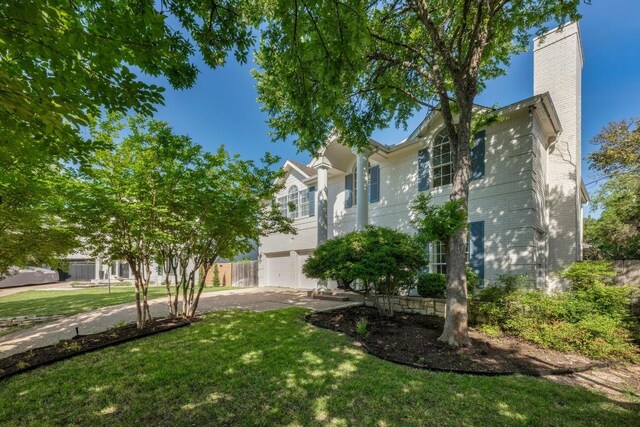 6202 Sotol Cv, Austin, TX 78759 - view of front of house featuring a front yard, a chimney, a garage, and driveway