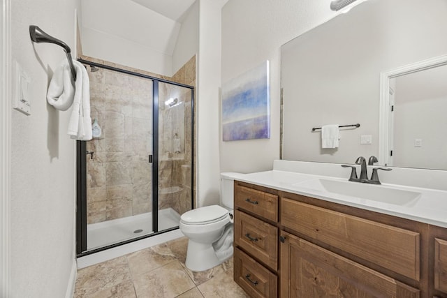 bathroom featuring vanity, a shower stall, and toilet