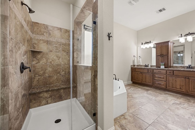 bathroom featuring double vanity, a stall shower, a sink, and a bathing tub