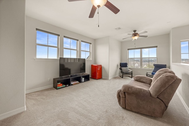 carpeted living room with visible vents and baseboards