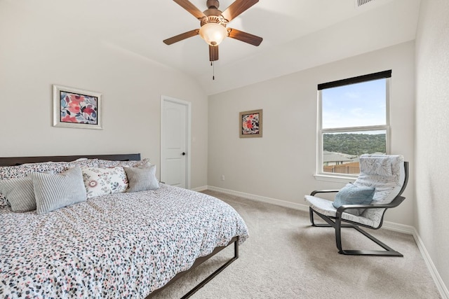 bedroom featuring light carpet, vaulted ceiling, a ceiling fan, and baseboards